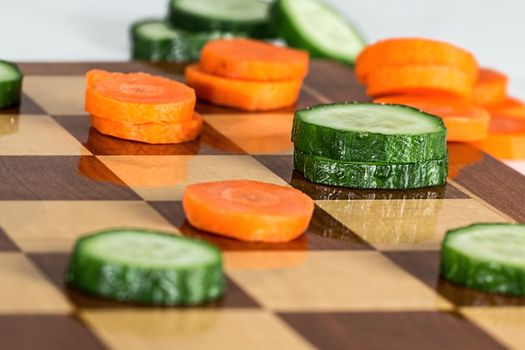 In images Two kinds of multicolored ripe cherries tomatoes on a chessboard, top view. Vintage background. Concept of healthy food, detox, vitamins, dieting