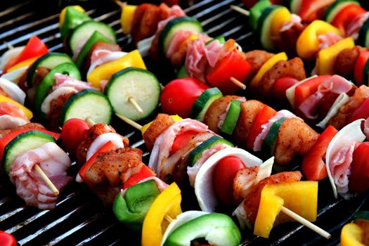 In images Bar-B-Q or BBQ with kebab cooking. coal grill of chicken meat skewers with mushroom and peppers. barbecuing dinner