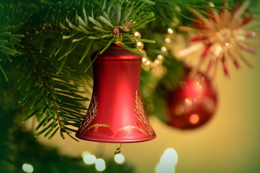 In images Closeup view of many beautiful old fashioned golden christmas bells hanging as new year toys, horizontal picture