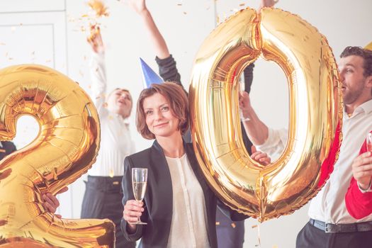 Business team of People Celebrating New Year in Modern Office. People Have Fun. Indoor Party. Celebrating of New Year.