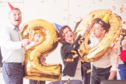 Business team of People Celebrating New Year in Modern Office. People Have Fun. Indoor Party. Celebrating of New Year.