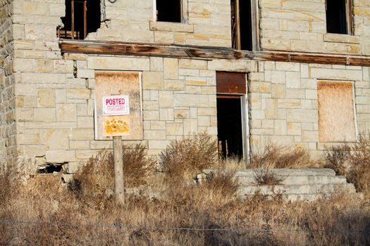 house with a no trespassing sign out front