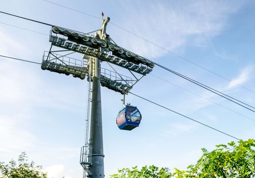 funicular road with a cabin on a background of blue sky and green trees in Georgia