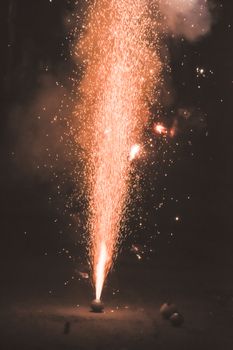 Bright and colorful fireworks showing display at night in City Street during Diwali festival celebration in Kolkata India. Close-up. Copy space room for text.