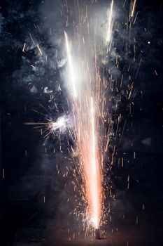 Bright and colorful fireworks showing display at night in City Street during Diwali festival celebration in Kolkata India. Close-up. Copy space room for text.