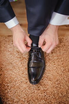 Groom black elegant shoes. Wedding detail. Close up