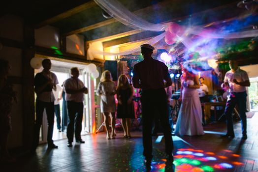 Bride and groom dancing the first dance at their wedding day. Guest on the dancefloor