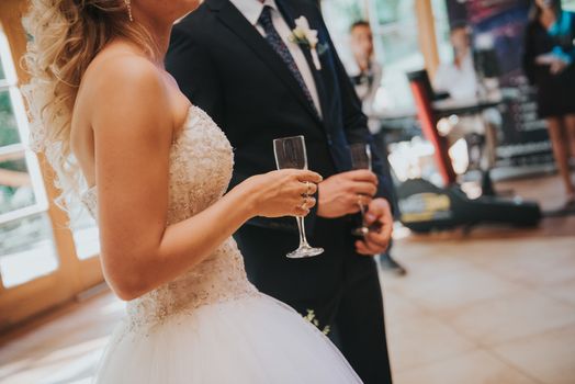 first toast of the bride and groom with a glass of champagne