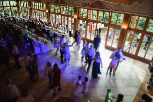 Bride and groom dancing the first dance at their wedding day. Guest on the dancefloor
