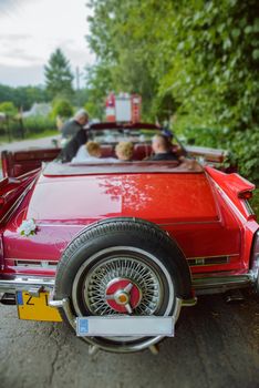 Luxury wedding car decorated with beautiful flowers. Brides and grooms wedding day