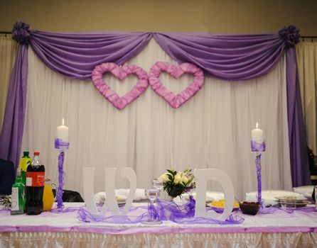 Beautifully decorated wedding table and other details at wedding hall. Wedding day