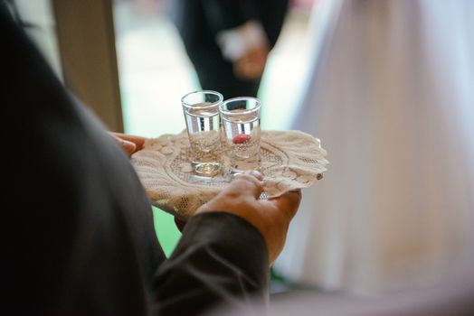 Traditional polish greeting the bride and groom by the parents with bread and salt. Vodka also in glasses.