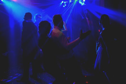 Bride and groom dancing the first dance at their wedding day. Guest on the dancefloor