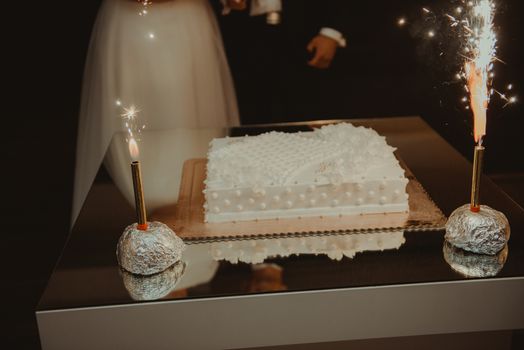 Delicious Wedding Cake at the party. Smoke and fire effects