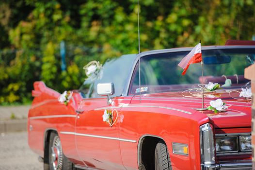 Luxury wedding car decorated with beautiful flowers. Brides and grooms wedding day
