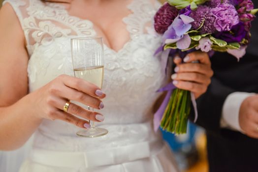 first toast of the bride and groom with a glass of champagne