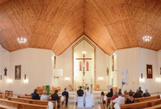 Bride and groom at church wedding during ceremony. Beautiful decoration