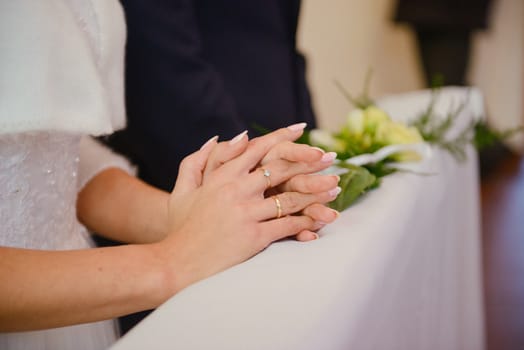 Bride and groom at church wedding during ceremony. Beautiful decoration