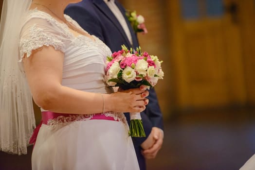 Bride and groom at church wedding during ceremony. Beautiful decoration