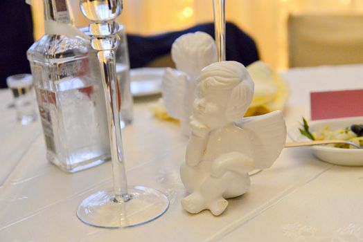 Bottle of cold vodka and wine bottle in bucket with ice and orange juice in jug on table, copy space. Alcohol bottles in ice bucket in restaurant. Wedding party