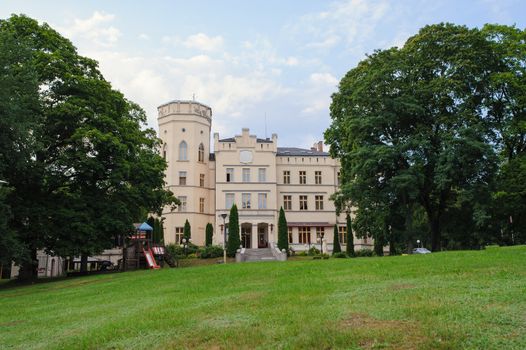 Renaissance historic palace in Poland, surrounding by beautiful green garden