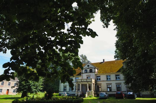Renaissance historic palace in Poland, surrounding by beautiful green garden