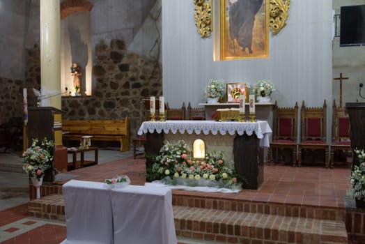 Church sanctuary before a wedding ceremony. Empty chairs for bride and groom