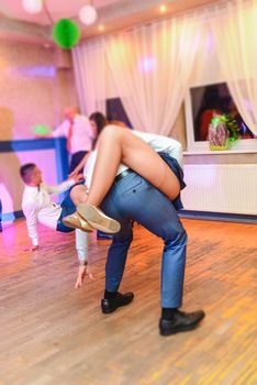Bride and groom dancing the first dance at their wedding day. Guest on the dancefloor