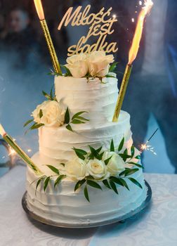 Delicious Wedding Cake at the party. Smoke and fire effects