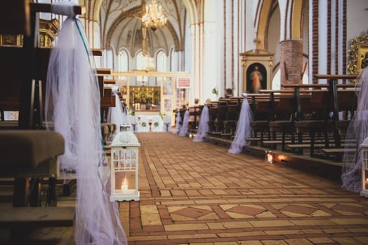 Church sanctuary before a wedding ceremony. Empty chairs for bride and groom