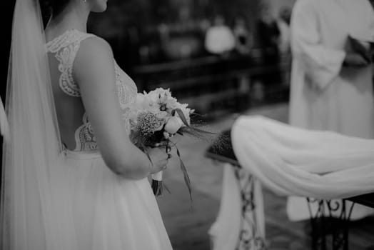 Bride and groom at church wedding during ceremony. Beautiful decoration