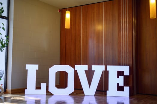 Illuminated Love sign in large letters at a wedding reception.