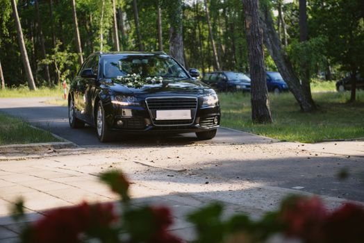 Luxury wedding car decorated with beautiful flowers. Brides and grooms wedding day