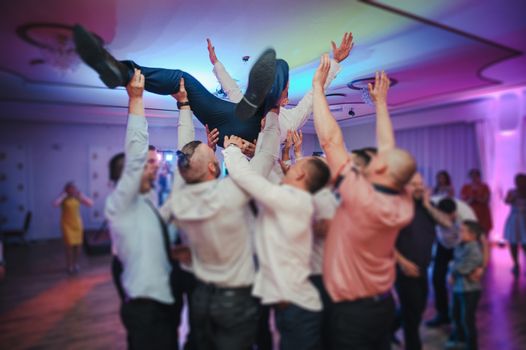 Bride and groom dancing the first dance at their wedding day. Guest on the dancefloor