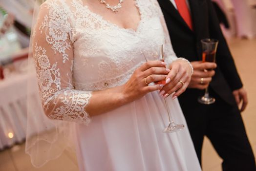 first toast of the bride and groom with a glass of champagne