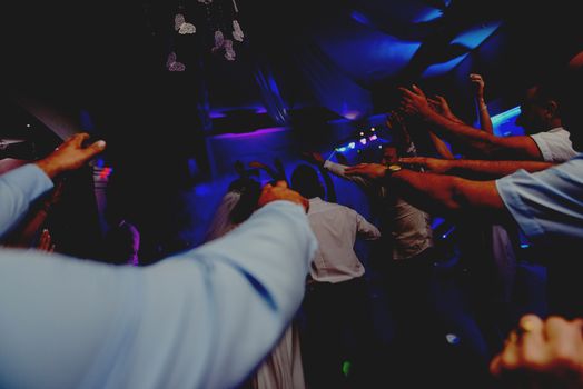 Bride and groom dancing the first dance at their wedding day. Guest on the dancefloor