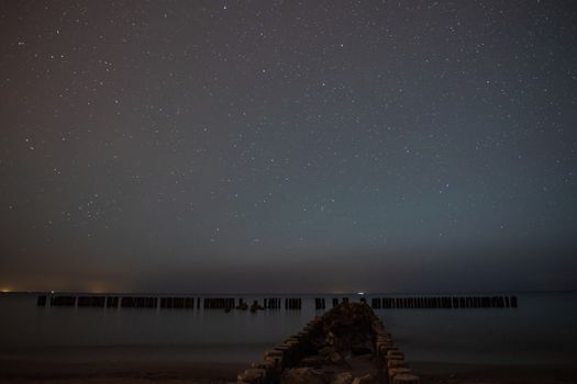 A photograph of a startrails in the sky under the starry sky