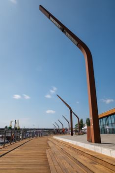 Modern and wooden marina club building in Szczecin, Poland. Boats, motorboat moored at the bank.