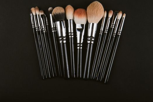 close up of a make up powder and a brush. makeup brush with powder foundation