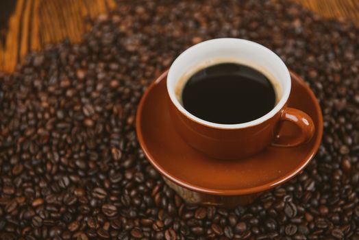 Coffee cup and beans on a background