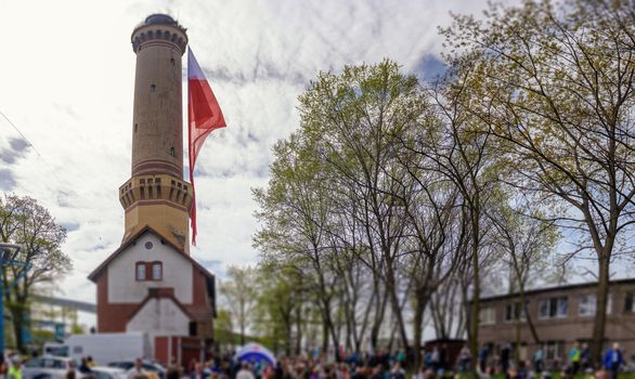 Polish flag hung on at historical lighthouse located in Swinoujscie, Poland, The construction was build in 1828 and height is 65 meters. 19th century. Top tallest Lighthouse in the World