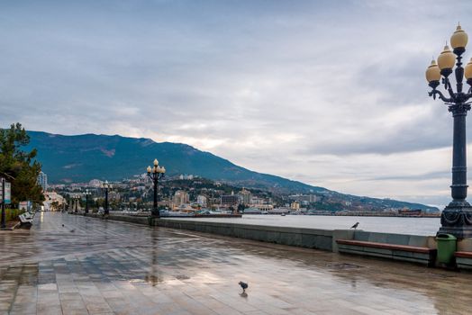 Walk along the embankment of the Yalta resort on an autumn rainy day, the Crimea peninsula, Russia