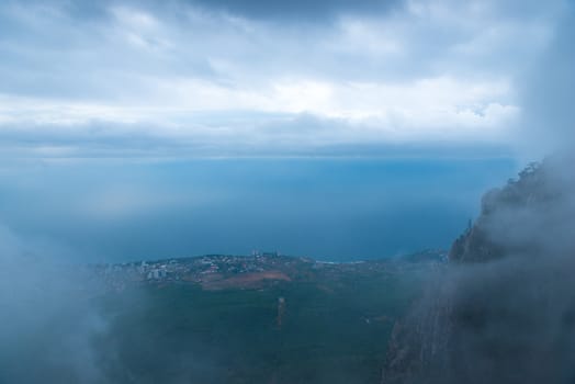 Beautiful view from a height through the clouds to the sea and the shore