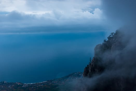 Beautiful view from the cliff through the clouds to the sea and shore