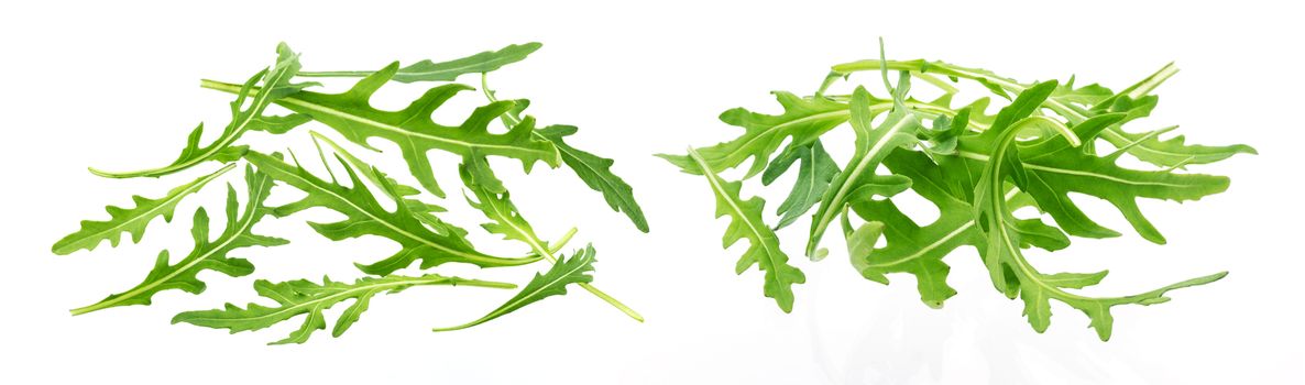 Rucola. Heap of fresh arugula leaves isolated on white background with clipping path