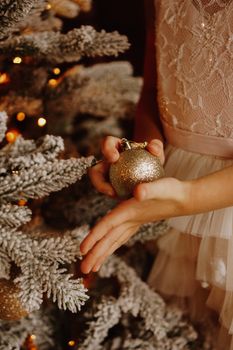 A child holding Christmas ball. Christmas vertical card design. Copy space. Close-up