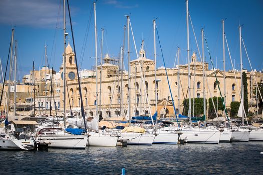 The yachts and boats moored in the harbor in Dockyard creek in front of Malta Maritime Museum. Birgu, Malta.