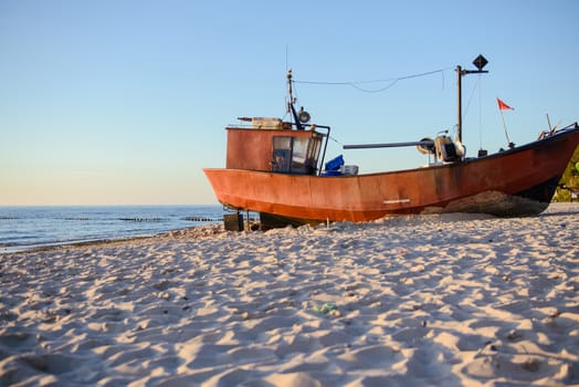 fisherman boats at sunrise time on the beach in summer