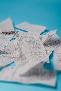 Pile of shopping receipts on a blue background
