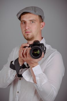 Young man using a professional camera in studio